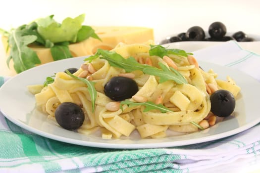 Pasta with pine nuts, pesto, olives and fresh rucola