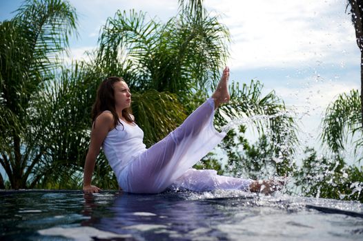 Woman relaxing in a paradise swimming pool in a resort in Porto Belo, Santa Catarina, Brazil