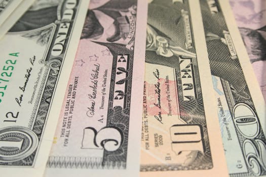 a pile of dollar bills in front of white background