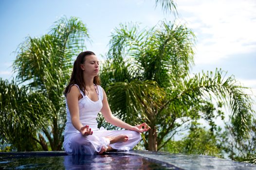 Woman relaxing in a paradise swimming pool in a resort in Porto Belo, Santa Catarina, Brazil