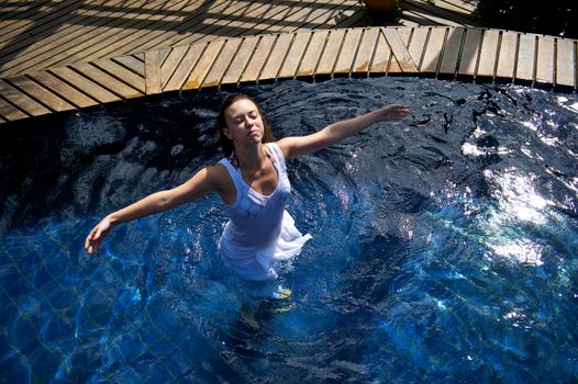 Woman relaxing in a paradise swimming pool in a resort in Porto Belo, Santa Catarina, Brazil