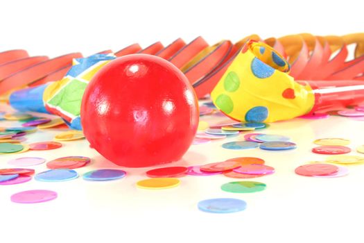 Noisemaker with a red clown nose, colored confetti and streamers