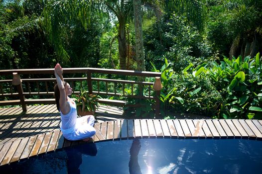 Woman relaxing in a paradise swimming pool in a resort in Porto Belo, Santa Catarina, Brazil