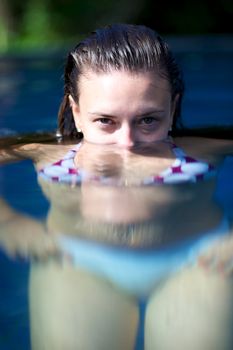 Woman relaxing in a paradise swimming pool in a resort in Porto Belo, Santa Catarina, Brazil