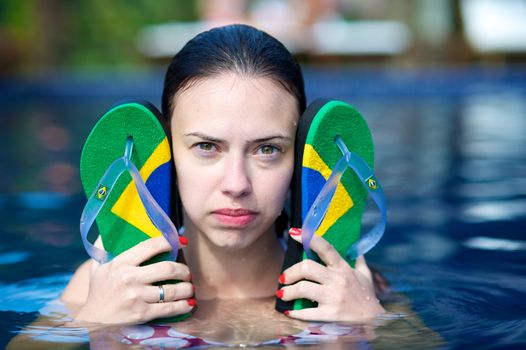 Woman relaxing in a paradise swimming pool in a resort in Porto Belo, Santa Catarina, Brazil