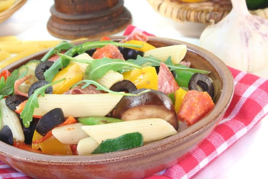 Penne salad with eggplant, zucchini, peppers, olives and rocket