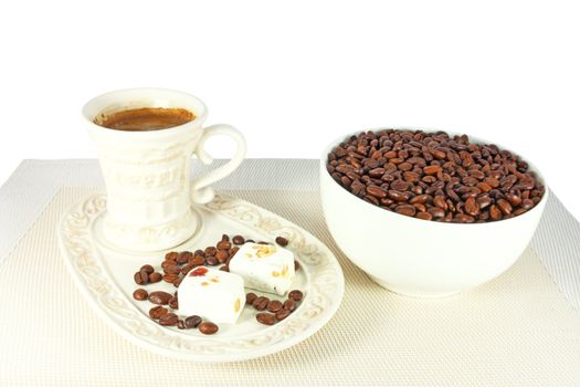 Coffee, coffee beans and pieces of almond nougat