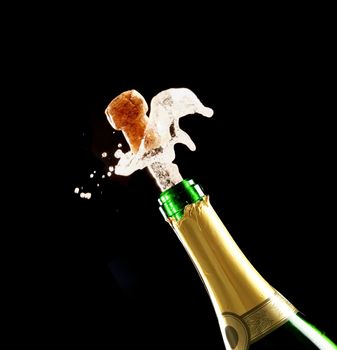 Bottle of champagne just opened with cork being expelled