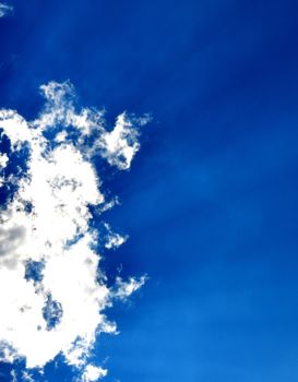 Blue sky with clouds and sun rays