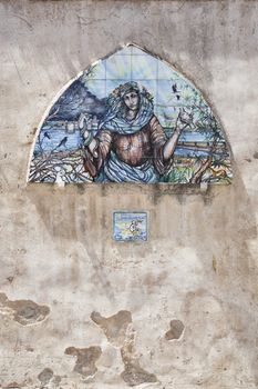 Holy painting on the wall, building facade in orbetello, Italy.
