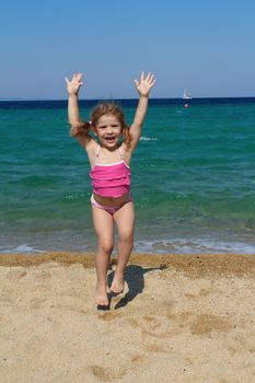 happy young girl jumping on the beach