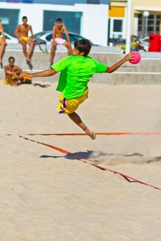 CADIZ, SPAIN - JULY 19: Unidentified players compete in a match between Zonabalonmano.com and BMPY Los Coñetas in the 19th league of beach handball of Cadiz on July 19, 2011 in Cadiz, Spain