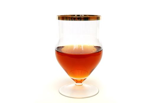 Zoomed glass with cognac standing on white background