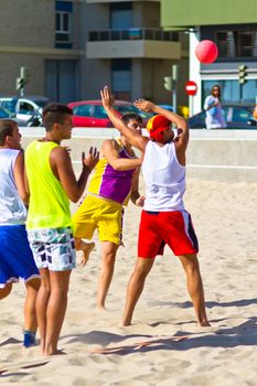 CADIZ, SPAIN - JULY 19: Unidentified players compete in a match between Los Negritos and Ademar Adentro in the 19th league of beach handball of Cadiz on July 19, 2011 in Cadiz, Spain