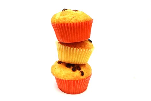 Zoomed tasty yellow three muffins on each other