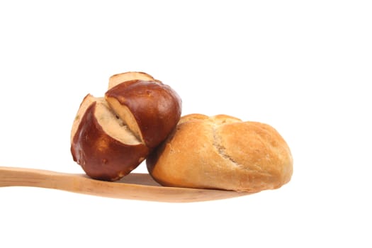 Two buns on a wooden spoon against a white background