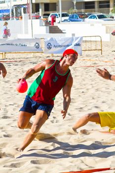 CADIZ, SPAIN - JULY 19: Unidentified players compete in a match between Los Negritos and Ademar Adentro in the 19th league of beach handball of Cadiz on July 19, 2011 in Cadiz, Spain