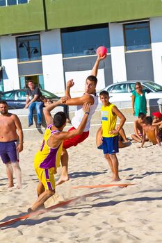 CADIZ, SPAIN - JULY 19: Unidentified players compete in a match between Los Negritos and Ademar Adentro in the 19th league of beach handball of Cadiz on July 19, 2011 in Cadiz, Spain