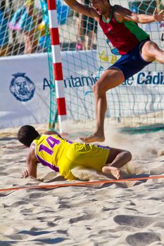 CADIZ, SPAIN - JULY 19: Unidentified players compete in a match between Los Negritos and Ademar Adentro in the 19th league of beach handball of Cadiz on July 19, 2011 in Cadiz, Spain