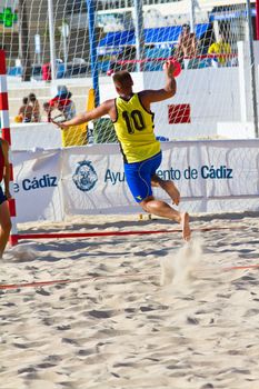 CADIZ, SPAIN - JULY 19: Unidentified players compete in a match between Los Negritos and Ademar Adentro in the 19th league of beach handball of Cadiz on July 19, 2011 in Cadiz, Spain