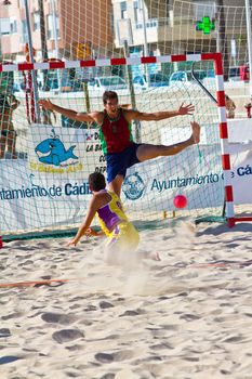 CADIZ, SPAIN - JULY 19: Unidentified players compete in a match between Los Negritos and Ademar Adentro in the 19th league of beach handball of Cadiz on July 19, 2011 in Cadiz, Spain