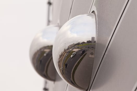 Mirror spheres as part of modern building facade reflect big city scene, Germany, Europe