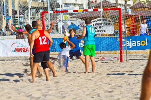 CADIZ, SPAIN - JULY 19: Unidentified players compete in a match between BMPY LAM Chiclana and Los Legendarios in the 19th league of beach handball of Cadiz on July 19, 2011 in Cadiz, Spain