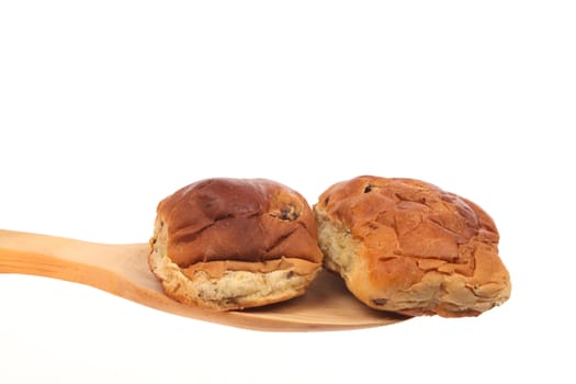 Bread on a wooden spoon against a white background