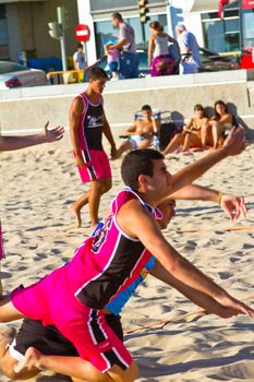 CADIZ, SPAIN - JULY 19: Unidentified players compete in a match between Zonabalonmano.com and CadizSur Seguros BMPY in the 19th league of beach handball of Cadiz on July 19, 2011 in Cadiz, Spain