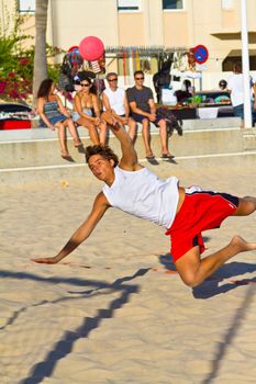CADIZ, SPAIN - JULY 19: Unidentified players compete in a match between Los Negritos and Autoescuela Barquin in the 19th league of beach handball of Cadiz on July 19, 2011 in Cadiz, Spain