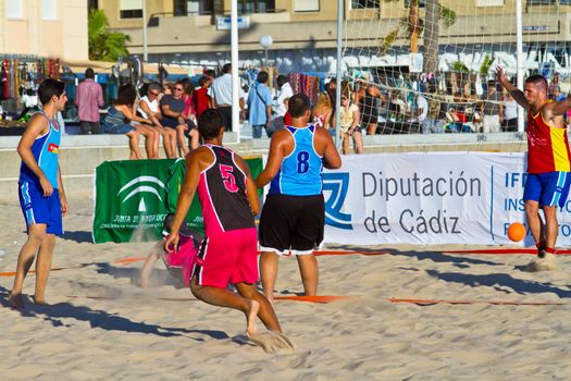 CADIZ, SPAIN - JULY 19: Unidentified players compete in a match between Zonabalonmano.com and CadizSur Seguros BMPY in the 19th league of beach handball of Cadiz on July 19, 2011 in Cadiz, Spain