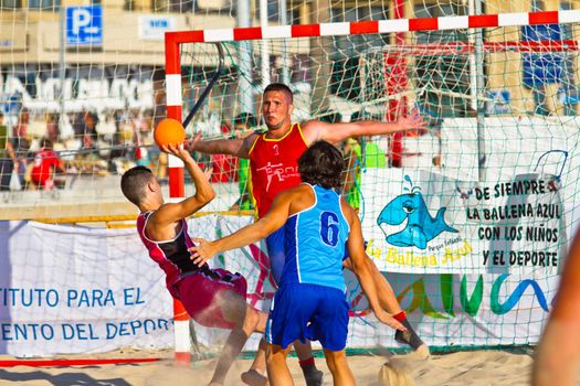 CADIZ, SPAIN - JULY 19: Unidentified players compete in a match between Zonabalonmano.com and CadizSur Seguros BMPY in the 19th league of beach handball of Cadiz on July 19, 2011 in Cadiz, Spain