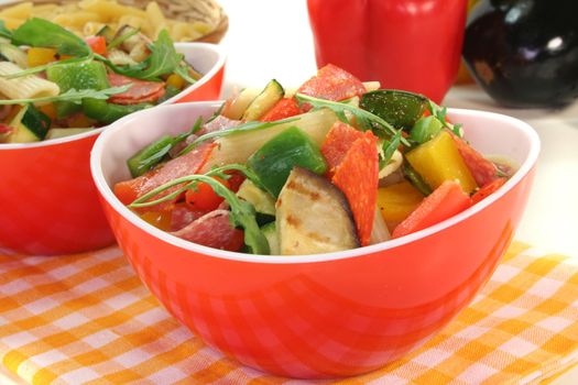 Penne salad with eggplant, zucchini, peppers, olives and rocket