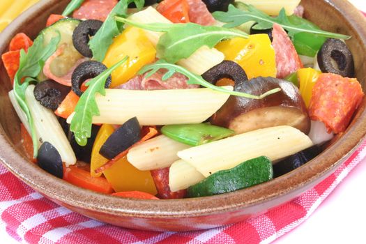 Penne salad with eggplant, zucchini, peppers, olives and rocket
