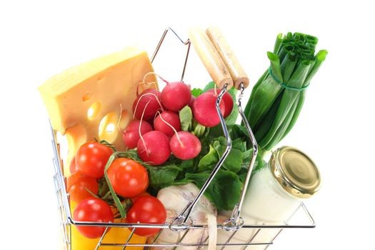 Shopping basket with milk, cheese and mixed vegetables