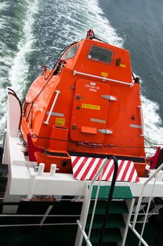 A freefall lifeboat on a cargo ship ready for rescue