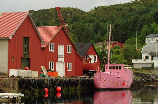 Pink fishing boat in a Norwegian harbor