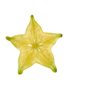 A yellow carambola slice photographed from close using light from the back to highlight the details