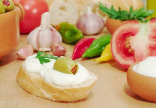 Baguette with cream cheese, olive and other fresh vegetables