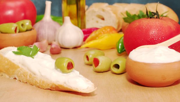 Baguette with cream cheese, olive and other fresh vegetables