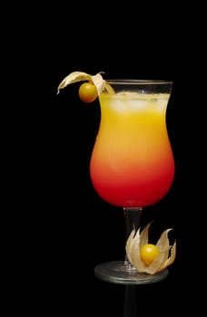 The Cocktail Tequila Sunrise with Physalis Fruit as Decoration isolated on Black Background