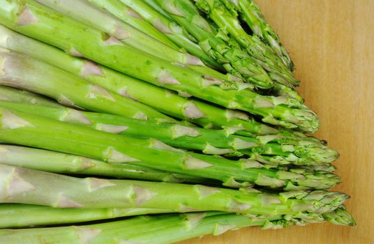 A Bundle of Green Asparagus on Wooden Board 