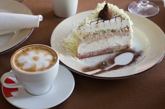 tasty cake at plate closeup with coffee cup