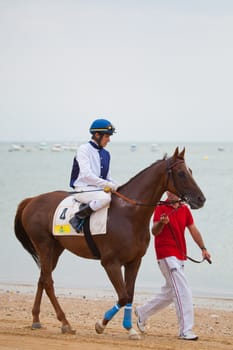 SANLUCAR DE BARRAMEDA, CADIZ, SPAIN - AUGUST 07: Unidentified rider at the start of race horses on Sanlucar de Barrameda beach on  August 07, 2010 in Sanlucar de Barrameda, Cadiz, Spain.
