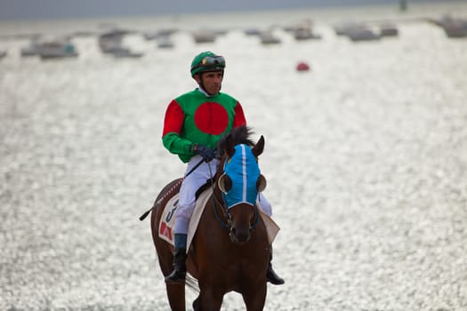 SANLUCAR DE BARRAMEDA, CADIZ, SPAIN - AUGUST 07: Unidentified rider at the start of race horses on Sanlucar de Barrameda beach on  August 07, 2010 in Sanlucar de Barrameda, Cadiz, Spain.