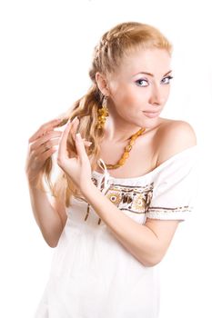 Redheaded woman unplaiting her hair over white