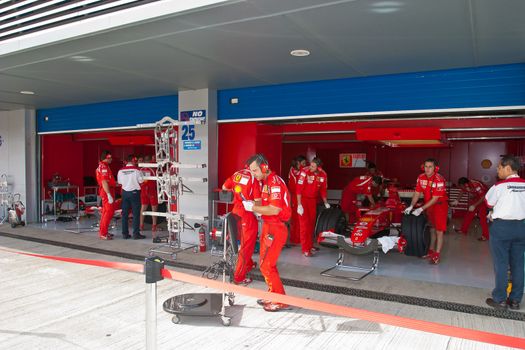 JEREZ DE LA FRONTERA, SPAIN - OCT 10: Engineers of Scuderia Ferrari working in the car on pits on training session on October 10, 2006 in Jerez de la Frontera , Spain