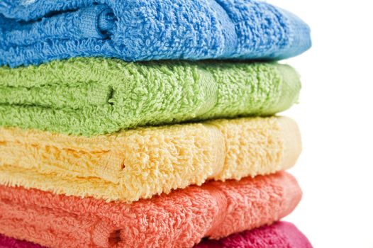 Colorful towels on a white background with space for text