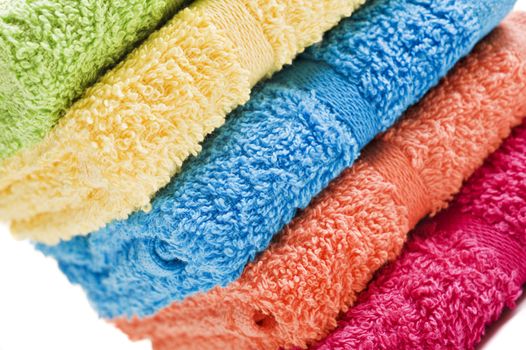 Colorful towels on a white background with space for text