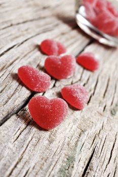 Red heart shaped jelly sweets on a rustic background